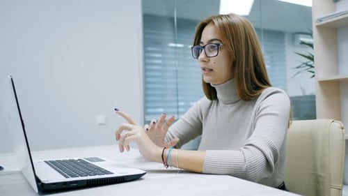 Businesswoman Holds Video Conference Consults Online By Video Link Woman in Office with Glasses