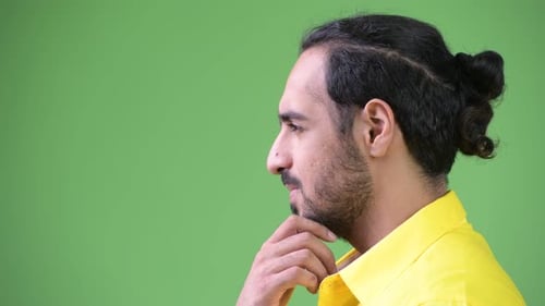 Profile View of Young Handsome Bearded Indian Businessman Thinking