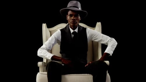 Stylish Woman in Fedora Sits Confidently on Chair