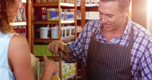 Woman purchasing bread at bakery store