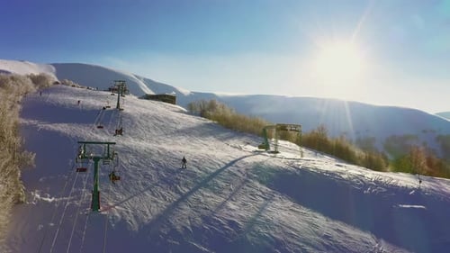 Old Ski Station on a Snowy Mountain Slope with a Lot of People on Skis and Snowboards