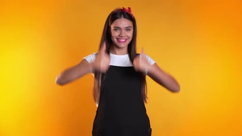 Young Woman Giving Two Thumbs Up and Smiling