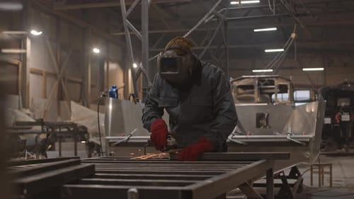 Man Using Sander in Dockyard