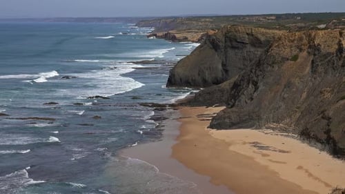 Sandy Beach and Cliff Rocks on Atlantic Coast