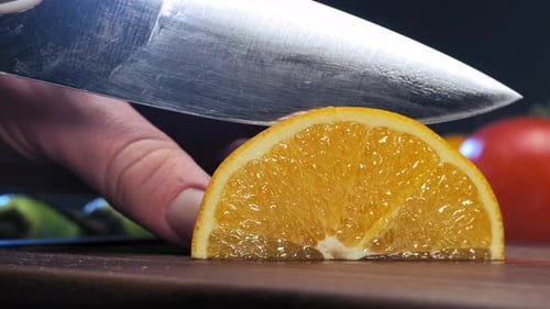 Fresh Orange Slices Being Cut on Board