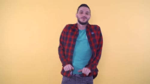 Man Dances Happily Against Yellow Background