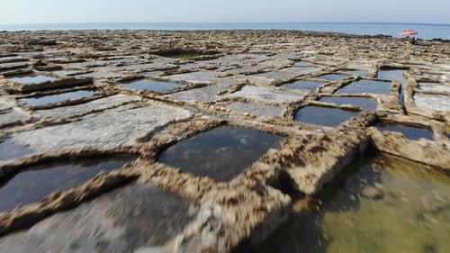 An aerial low-altitude drone fly over of the Salt Pans on the Island of Gozo in Malta.