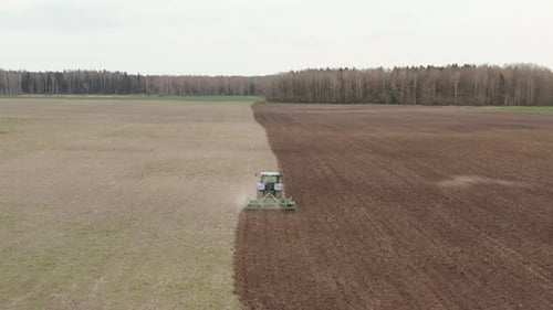Tractor Plows The Farm Field
