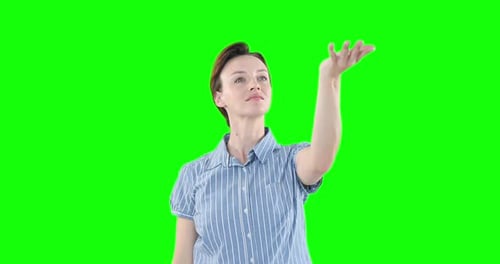 Caucasian woman raising hand on green background