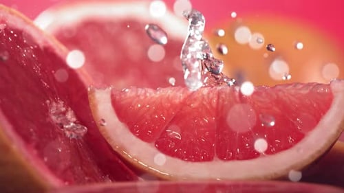 Close up of Water Splashing on Grapefruit