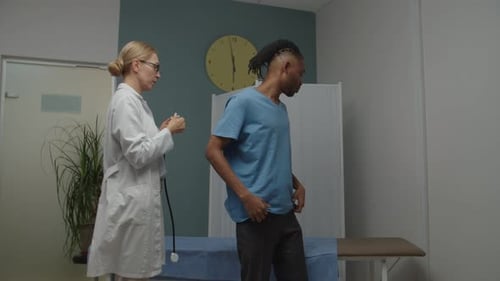 Doctor Examines Young Adult Man with Stethoscope