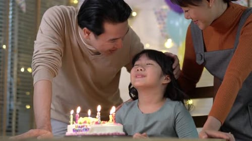 Family Celebrates Daughter's Birthday at Home with Cake