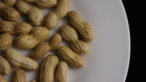Cinematic, rotating shot of peanuts on a white surface - PEANUTS 002