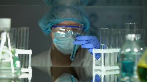 Researcher Pouring Green Substance in Blue Liquid, Checking Water Sediments