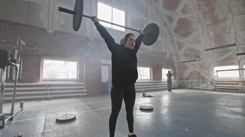 Woman Doing Overhead Squat with Barbell