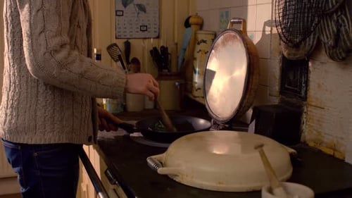 Man Cooking in Kitchen, Stirring Frying Pan