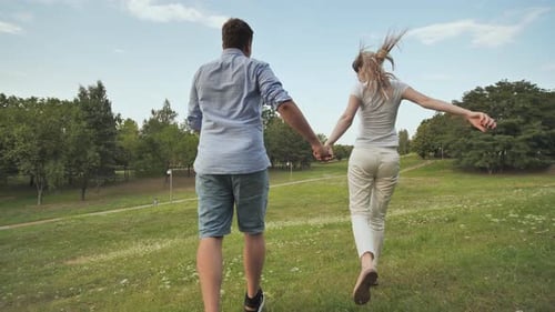 A Guy and a Girl Walk in the Park on a Summer Day
