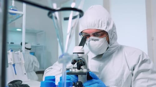 Scientist Using Microscope in Bright Laboratory Setting