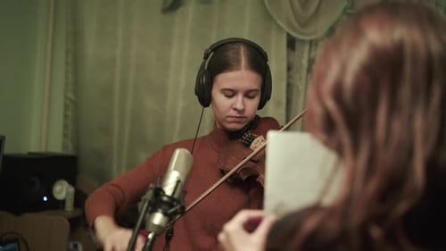 Woman Playing Violin in Recording Studio