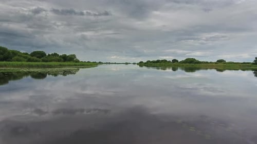 Flying Over Lake Surface with Reflection of Sky