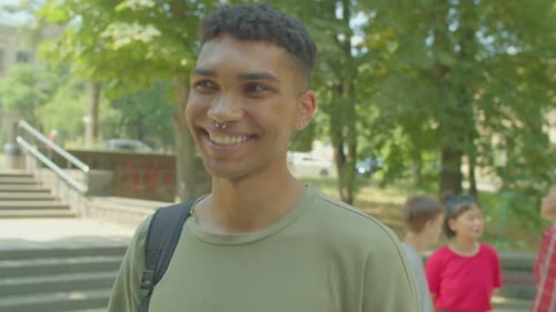 Smiling Young Adult Standing on a Campus