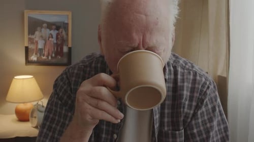 Senior Man Drinking Coffee at Home