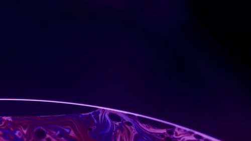 Closeup Abstract Shot of Edge of Soap Bubble's Film Surface in Purple