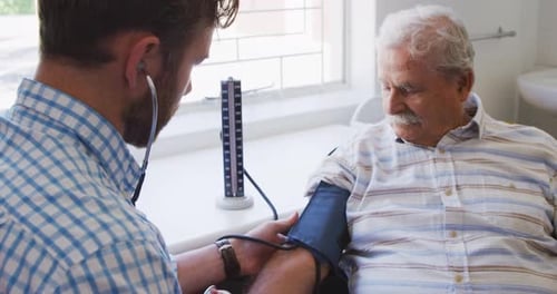 Doctor examining a senior man in a retirement home
