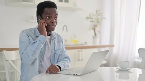 Young Adult Talking on Phone at Home