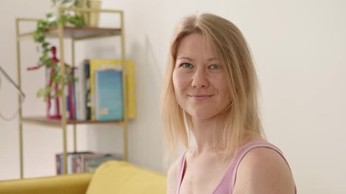 Woman Smiling Indoors in Close Up