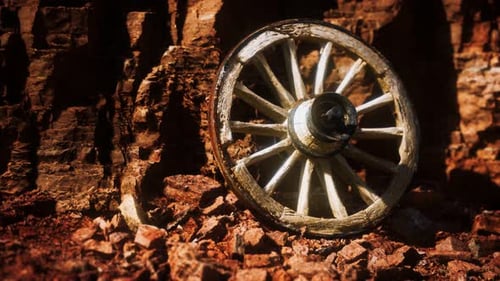 Old Wooden Cart Wheel in Rugged Rocky Landscape
