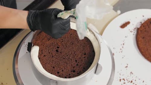 Pastry Chef Decorating Cake with Cream