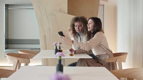 Pair of Young Women Making Selfie in Restaurant