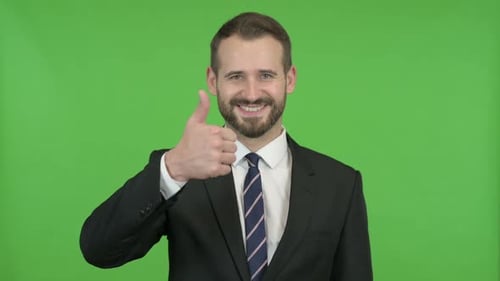 Young Businessman Showing Thumbs Up Against Chroma Key