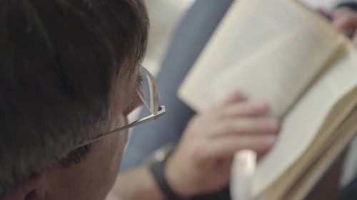 Close Up of Adult Reading Book