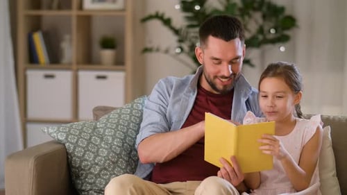 Dad and Daughter Reading a Book Together