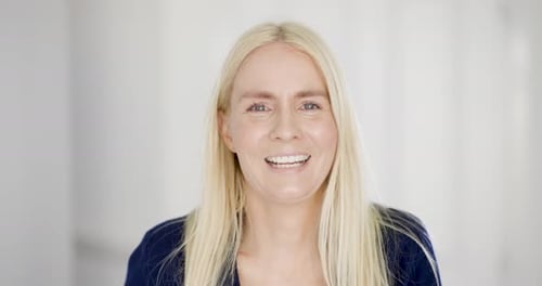 Smiling Blonde Woman Looking at Camera