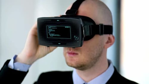Man Wearing VR Headset Displays Hologram