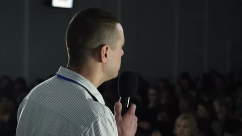 Male Public Speaker Talking at Trade Market Show