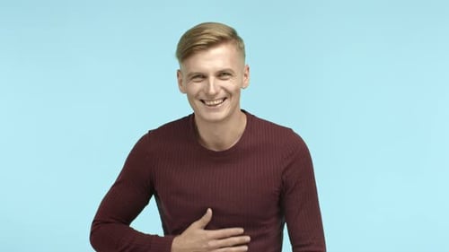 Young Man Laughing and Holding Stomach