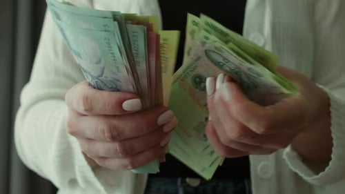 Close Up of Woman Holding Stack of Money