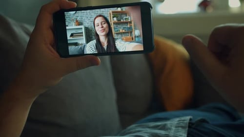 Close-up of Male Hand Holding Smartphone Making Video Call Talking To Girl