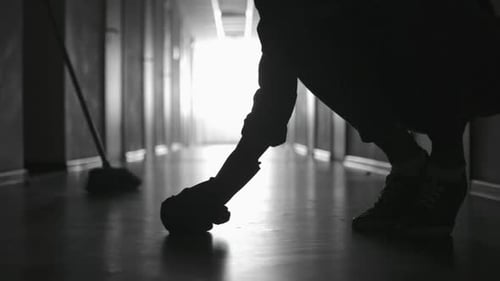 Silhouette of Janitor Scrubbing Floor