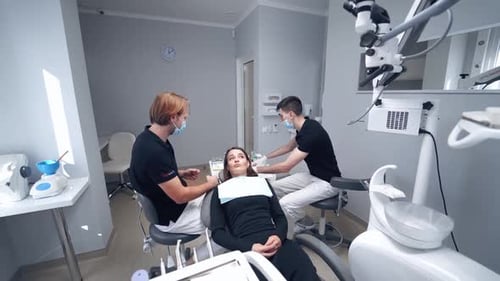 Stomatology interior of dental clinic. Female in stomatological cabinet with dentists