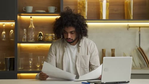 Muslim Man Throws Away Project Papers Sitting at Computer