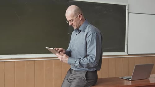 Portrait of Male University Professor at Blackboard