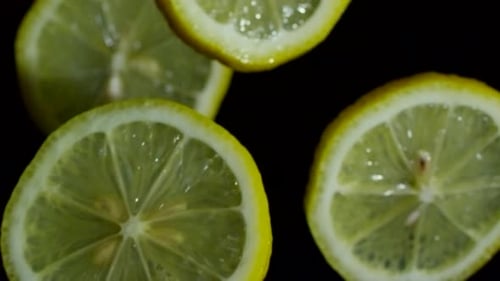Rotating Lemon Fruit Slices on Black Background