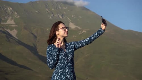 Woman Taking Selfie With Mountain Backdrop