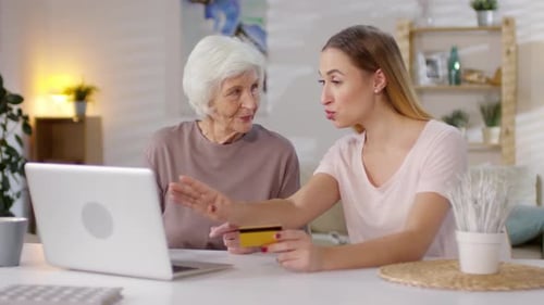 Woman Teaching Mother to Shop Online