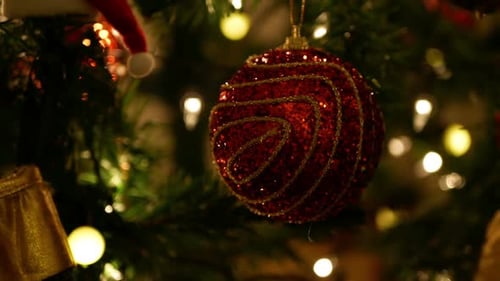 Red Christmas Ornament On Christmas Tree with Lights